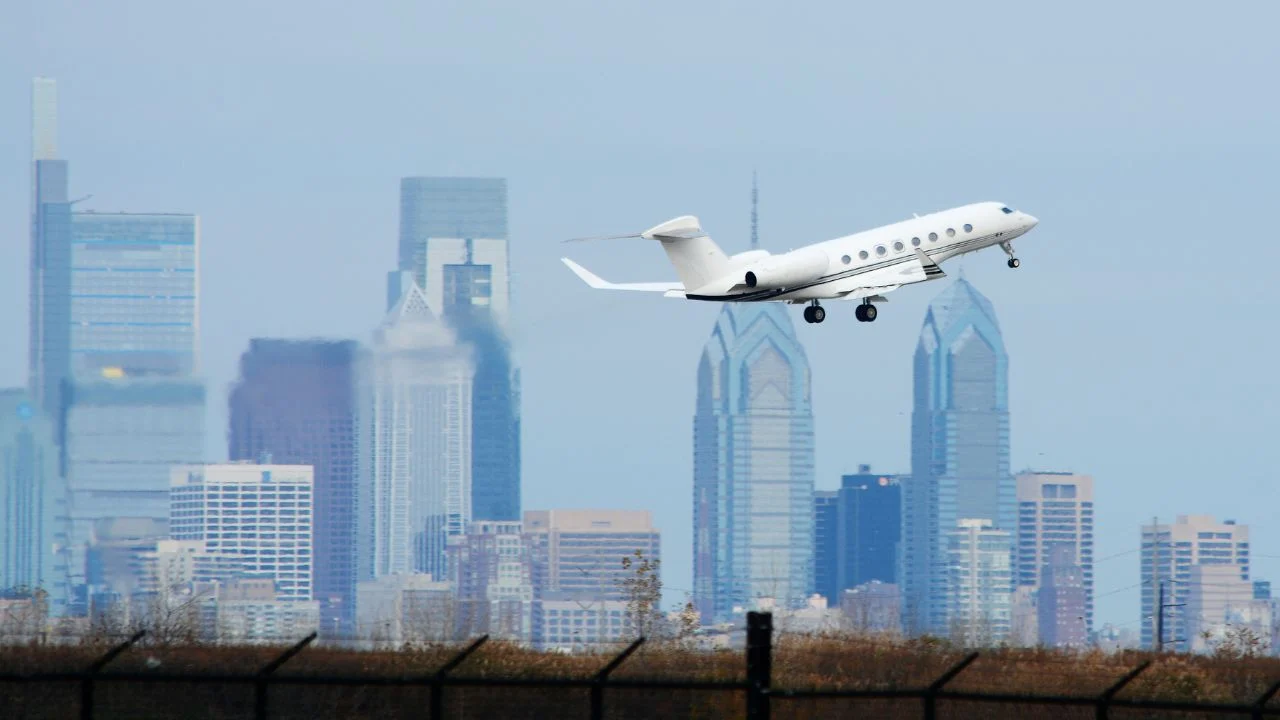 A Private Jet Flying in Front of the Philadelphia Skyline