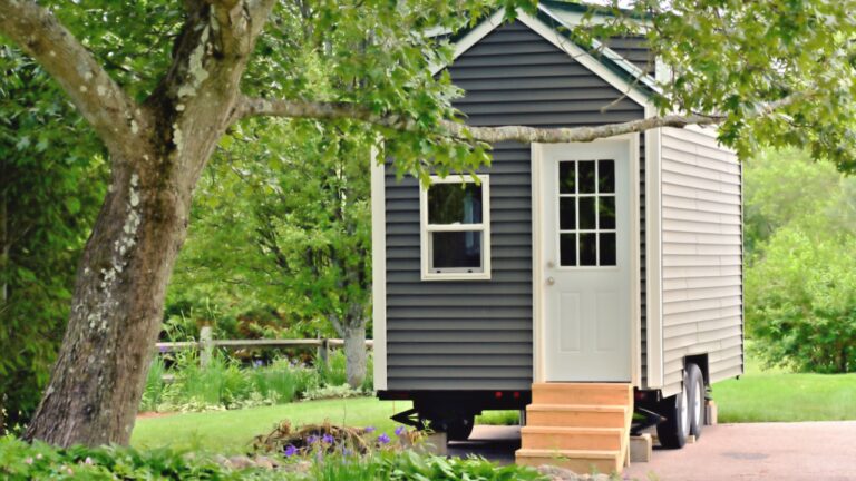 Landscape view of a tiny gray eco friendly house on wheels