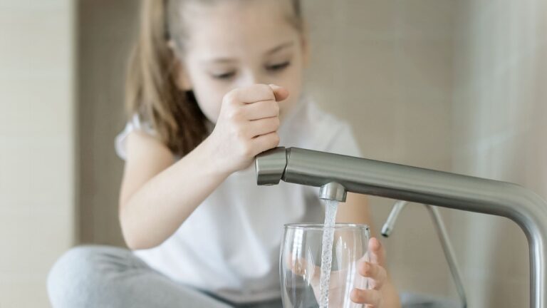 Child open water tap. Kitchen faucet. Glass of clean water. Pouring fresh drink. Hydration. Healthy lifestyle. Water quality check concept. World water monitoring day. Environmental pollution problem