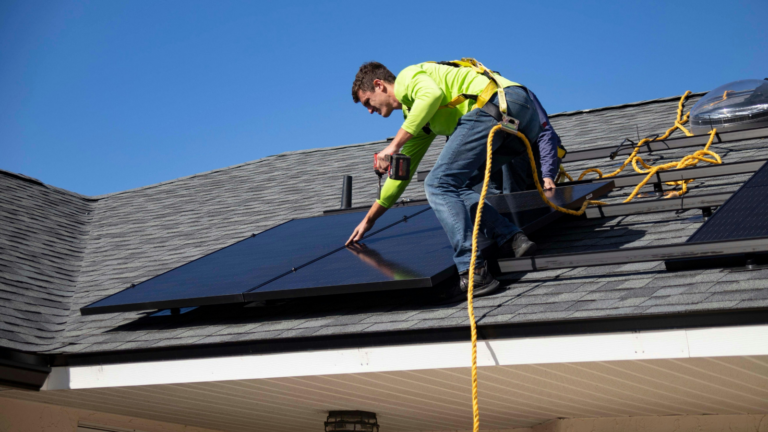 Man Installs Solar Panels
