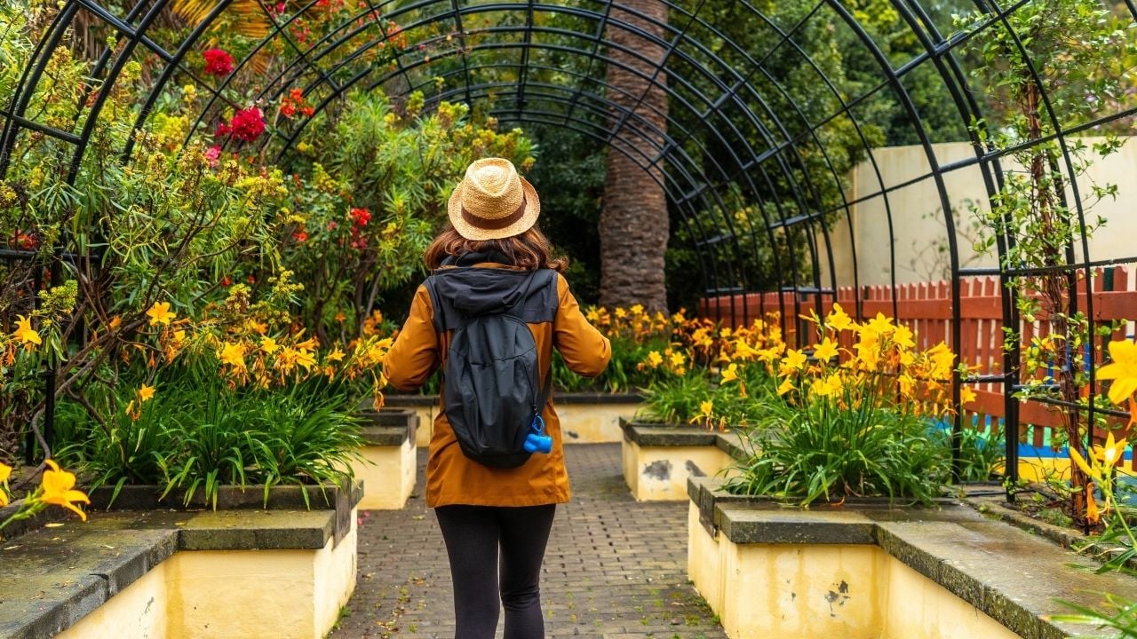 A woman walking through a beautiful botanical garden, a sustainable tourism concept in Arucas, Gran Canaria. Spain