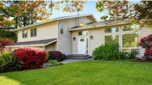 American home with well kept lawn and flowers. Enterance to the house