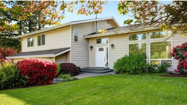 American home with well kept lawn and flowers. Enterance to the house