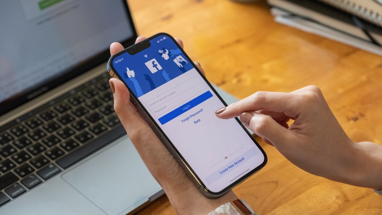 CHIANG MAI, THAILAND - OCT 17, 2021: Facebook social media app logo on log-in, sign-up registration page on mobile app screen on iPhone 13 Pro Max in person's hand working on e-commerce shopping.