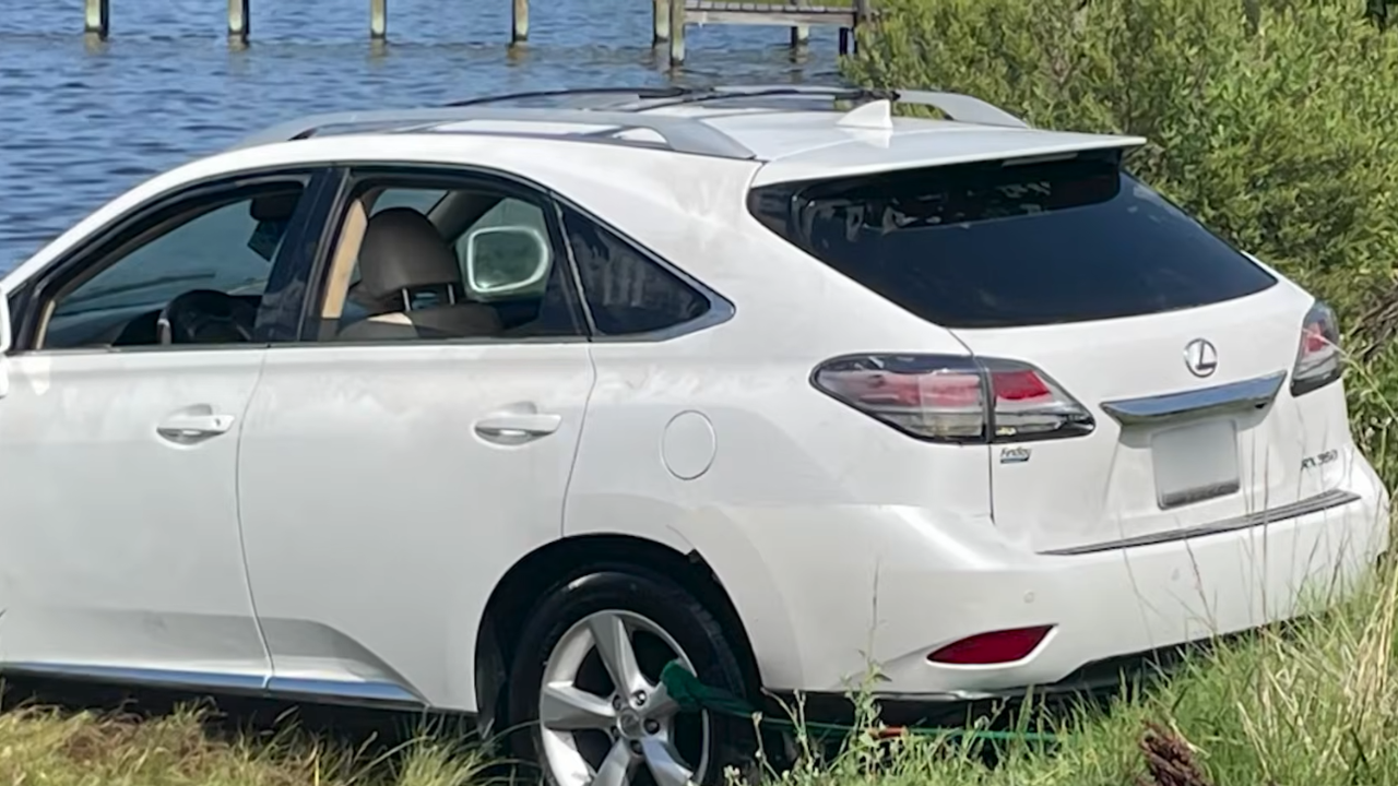 suv falls into water, kayak keeps driver afloat.