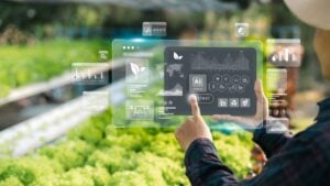 Agricultural technology concept, Ai system. A young man is working on a farm using a tablet controller with innovative technology for a smart farm system.