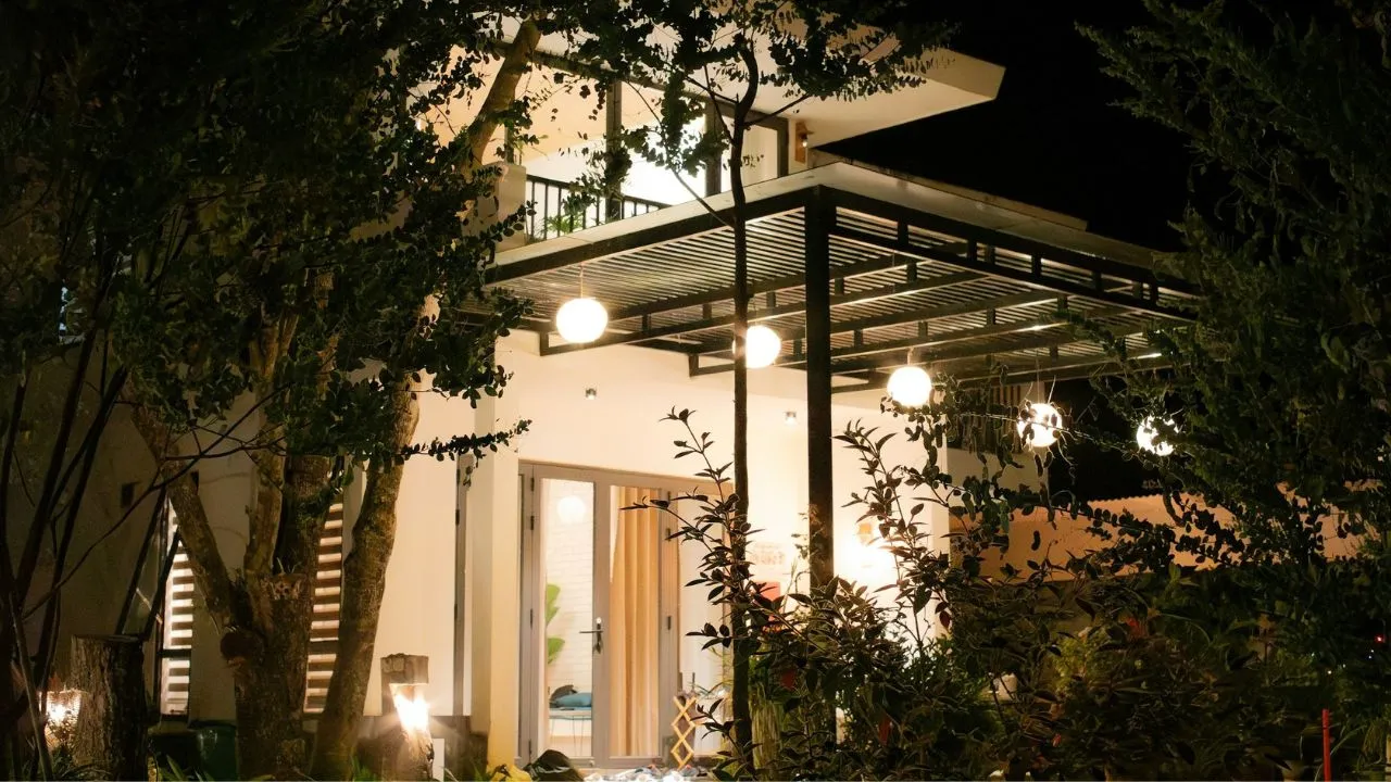 Modern house with outdoor lights at night.