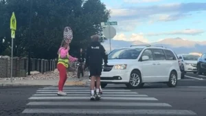 Crossing Guard Rushes To Protect Children as Car Moves Through Crosswalk