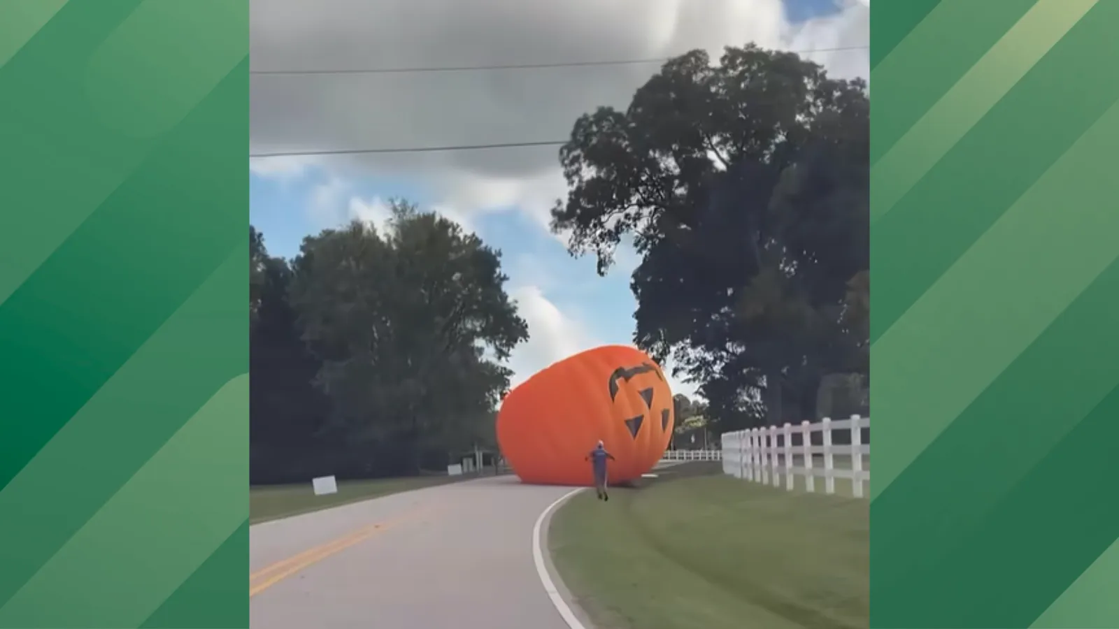 Giant pumpkin rolls down street.