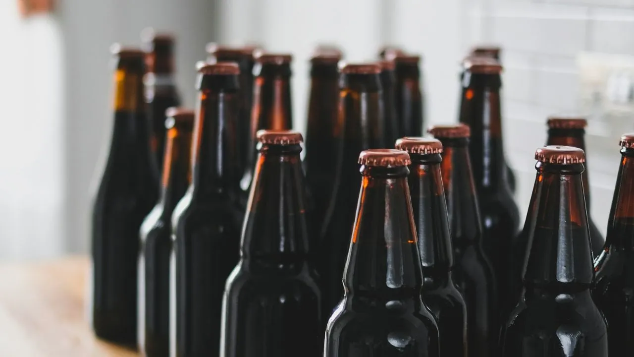 Black glass bottles on table top.